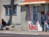A man sits in shade of a light pole at a bus stop in September in Phoenix. Soaring temperatures are making it harder to live in the United States' already hot, fast growing desert areas.