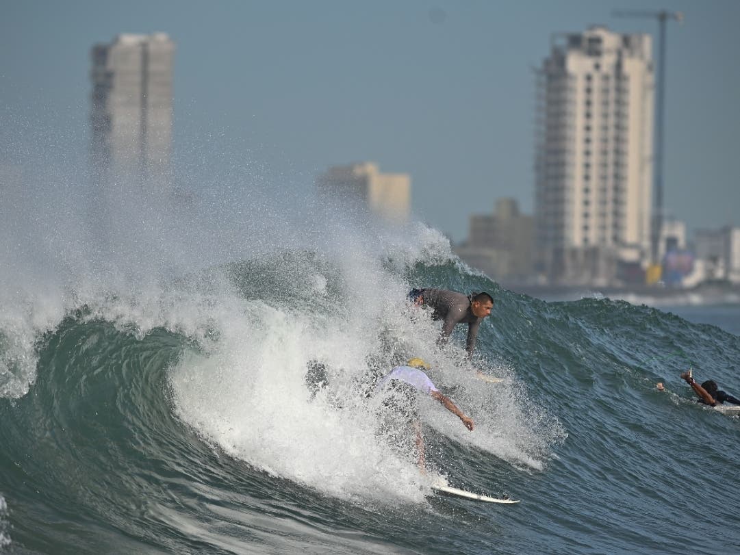 People surf at Pinitos beach prior landfall of tropical storm Pamela, in Mazatlan, Mexico, Tuesday. Hurricane Pamela weakened to a tropical storm Tuesday afternoon as it meandered off Mexico's Pacific coast.
