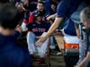 Boston Red Sox's Rafael Devers celebrates in the dugout after a grand slam home run against the Houston Astros during the second inning in Game 2 of baseball's American League Championship Series Saturday in Houston.