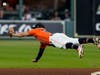 Houston Astros second baseman Jose Altuve can't get a glove on a single by Boston Red Sox's J.D. Martinez during the seventh inning in Game 2 of baseball's American League Championship Series Saturday in Houston.