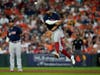 Boston Red Sox shortstop Xander Bogaerts throws out Houston Astros' Carlos Correa at first during the eighth inning in Game 2 of baseball's American League Championship Series Saturday in Houston. 