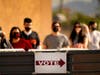 In this Nov. 3, 2020, file photo, voters stand in line outside a polling station, on Election Day in Mesa. Ron Watkins, a prolific promoter of false conspiracies about the 2020 election who is closely tied to QAnon, says he's running for Arizona Congress.