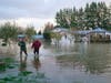 Sisters Myranda, left, and Krysten Archer walk through floodwater from their uncle's home Monday, Nov. 15, 2021, in Sedro-Woolley, Wash.