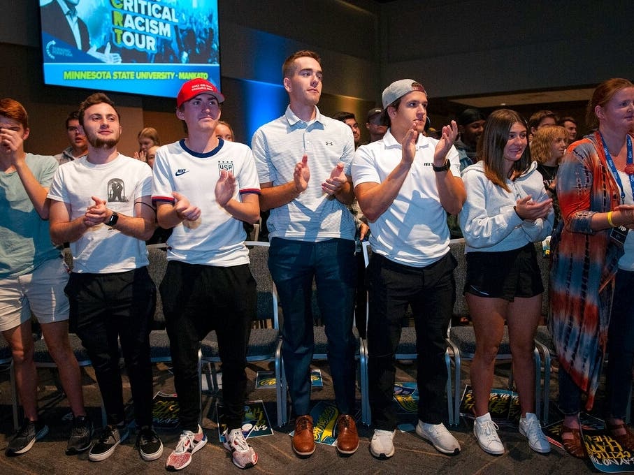 Minnesota State University Mankato students applaud Charlie Kirk as he finished his speech at the “Exposing Critical Racism Theory” tour. Kirk and his group, Turning Point USA, have built a following inflaming racial divides and stoking outrage. 