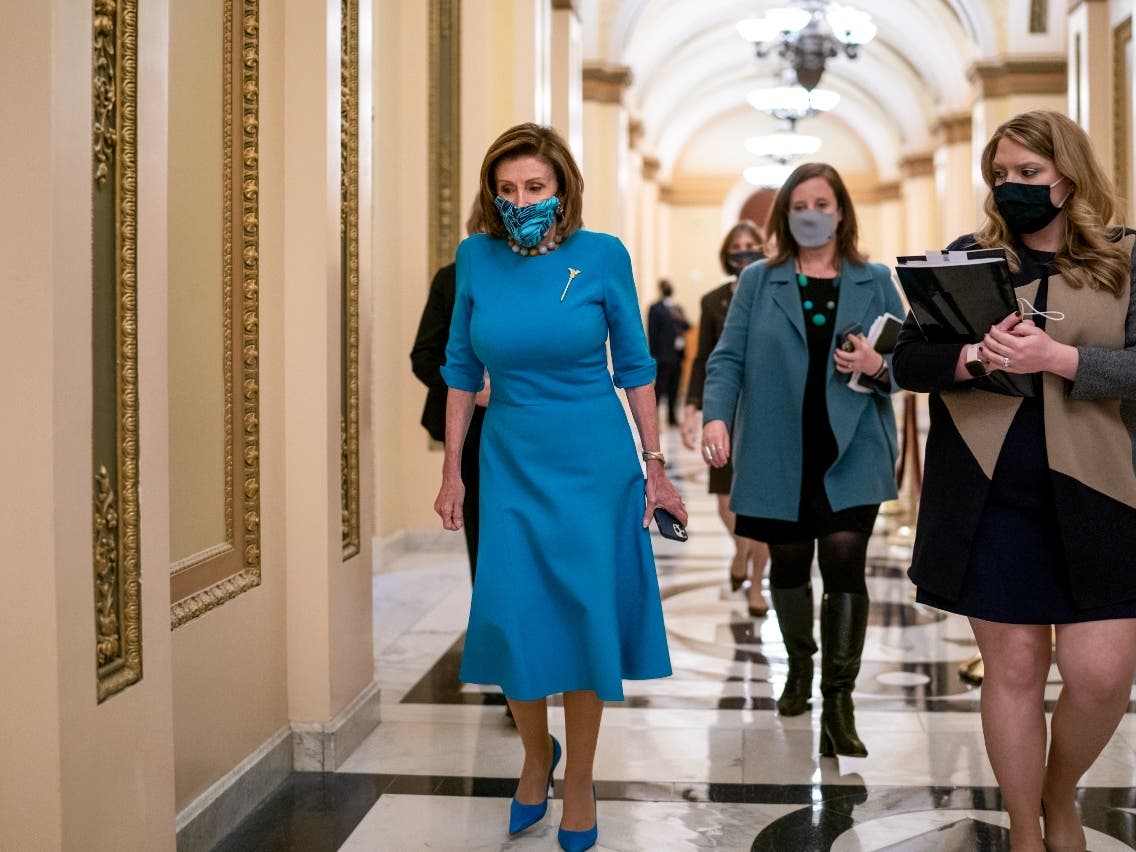 Speaker of the House Nancy Pelosi, D-California, leaves the chamber after midnight during a lengthy floor speech by House Minority Leader Kevin McCarthy, R-California, who disrupted a planned vote on President Joe Biden's domestic agenda.