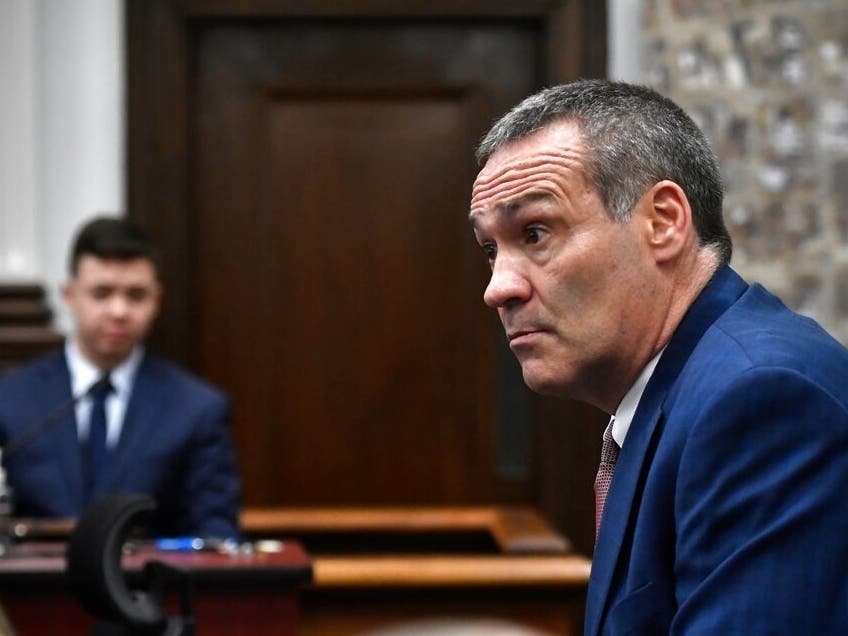 Kyle Rittenhouse, left, looks on as his attorney Mark Richards questions him as he testifies during his trial at the Kenosha County Courthouse.