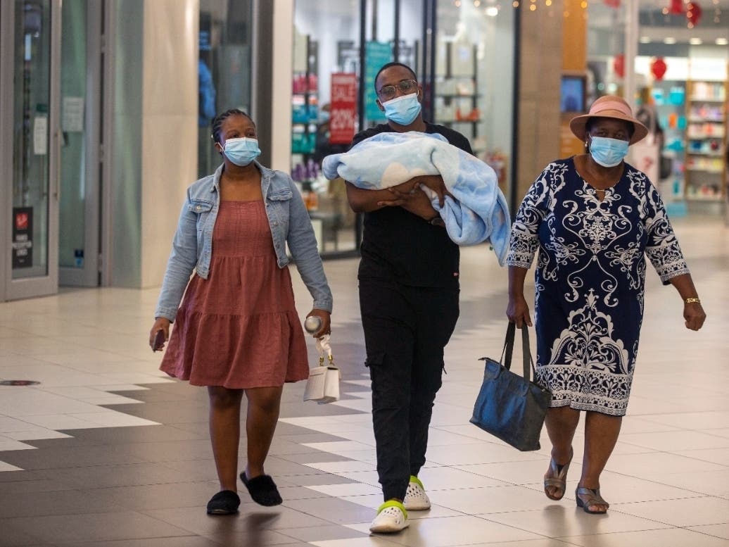 People with masks walk at a shopping mall in Johannesburg, South Africa, on Friday. Advisers to the World Health Organization are holding a special session Friday to assess a worrying new variant of the coronavirus that has emerged in South Africa.