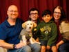Michael Olson, from left, Paul Olson, 18, Porter Olson, 10, and Nicole Olson sit for a family photo with their dog named "Dotty" at their home on Dec. 17 in Phoenix.
