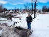 Ron Damario peers into what remains of his charred safe Monday in Louisville. Damario lost his home after a fire ripped through Boulder County on Thursday. 