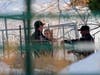 A woman looks on as Boulder County Sheriff's officers investigate the origins of the Marshall wildfire Monday in Boulder.