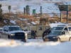 Boulder County Sheriff's officers work a road block Monday in the area where the Marshall wildfire could've started, officials said.