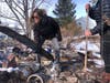 Karen England Horan sifts through the remains of her condo Tuesday looking for jewelry and family heirlooms after it was destroyed by a wildfire that swept through her neighborhood in Louisville.