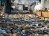 Shredded boxes and packages are seen at a section of the Union Pacific train tracks in downtown Los Angeles Friday, Jan. 14, 2022.