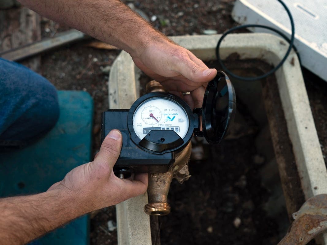 Cason Gilmer, a senior field customer service representative from the Las Virgenes Municipal Water District, installs an advanced water metering system in Agoura Hills, Calif., Wednesday, Jan. 5, 2022. 