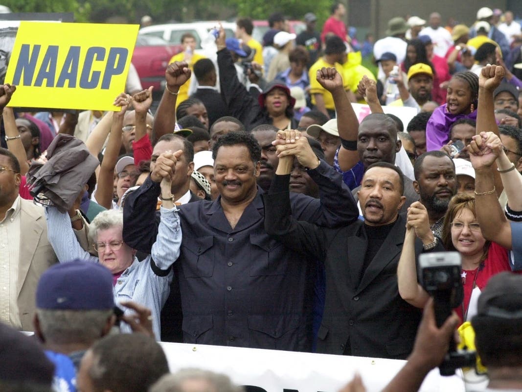  Jesse Jackson, founder of Rainbow/PUSH and NAACP president Kweisi Mfume, in the center, join hands as they arrive at Greenville County Square for a rally in a Dignity Day march on May 17, 2003, in Greenville, S.C. 