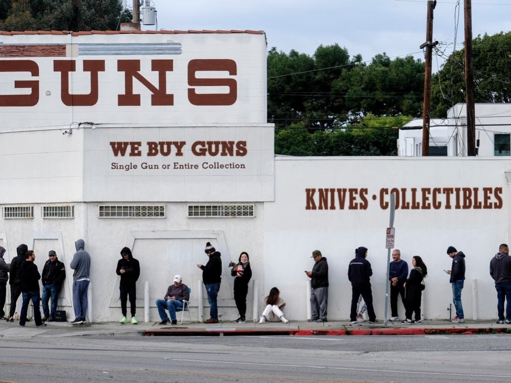 In this March 15, 2020 file photo people wait in a line to enter a gun store in Culver City, Calif. The 9th U.S. Circuit Court of Appeals on Thursday, Jan. 20, 2022, overturned two California counties orders shutting down gun and ammunition stores in 2020