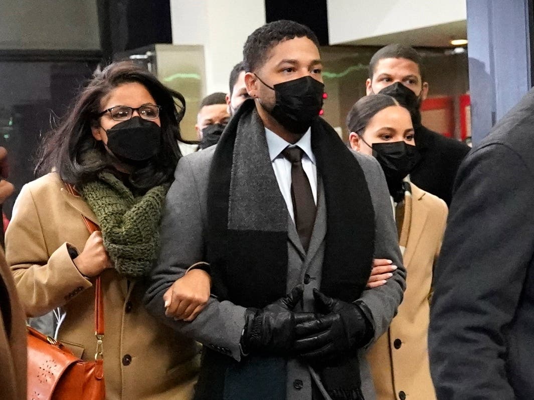 Actor Jussie Smollett, center, leaves the Leighton Criminal Courthouse with unidentified siblings, Thursday, Dec. 9, 2021, in Chicago.