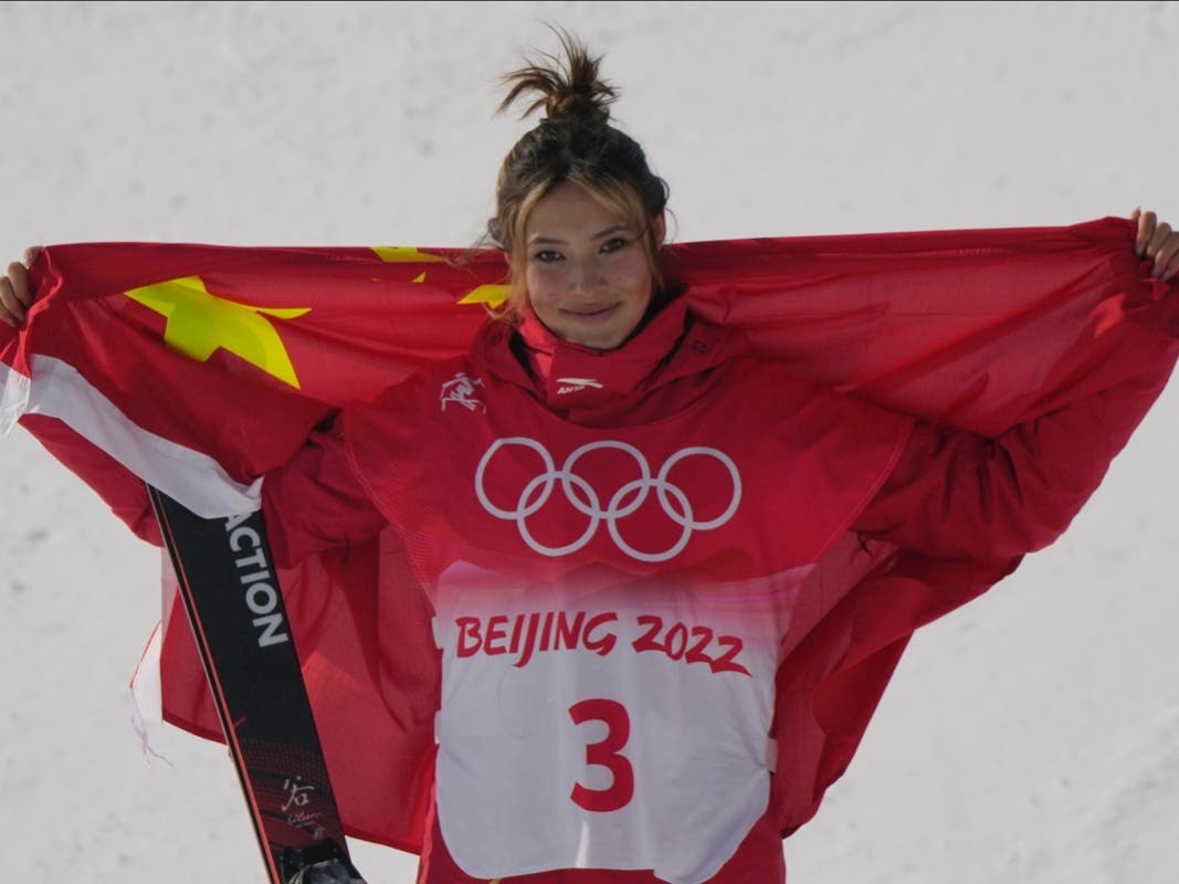 Silver medal winner China's Eileen Gu celebrates during the venue award ceremony for the women's slopestyle finals at the 2022 Winter Olympics, Tuesday, Feb. 15, 2022, in Zhangjiakou, China.