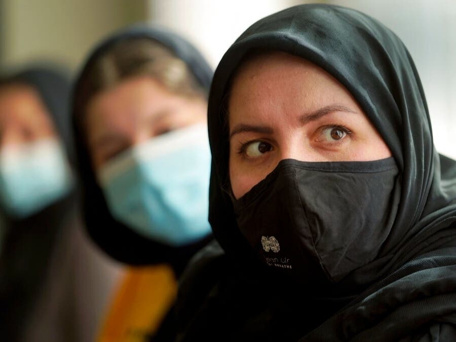Afghan refugee Mozhgan Entazari, right, talks about the challenge to find proper housing for her family in Southern California.