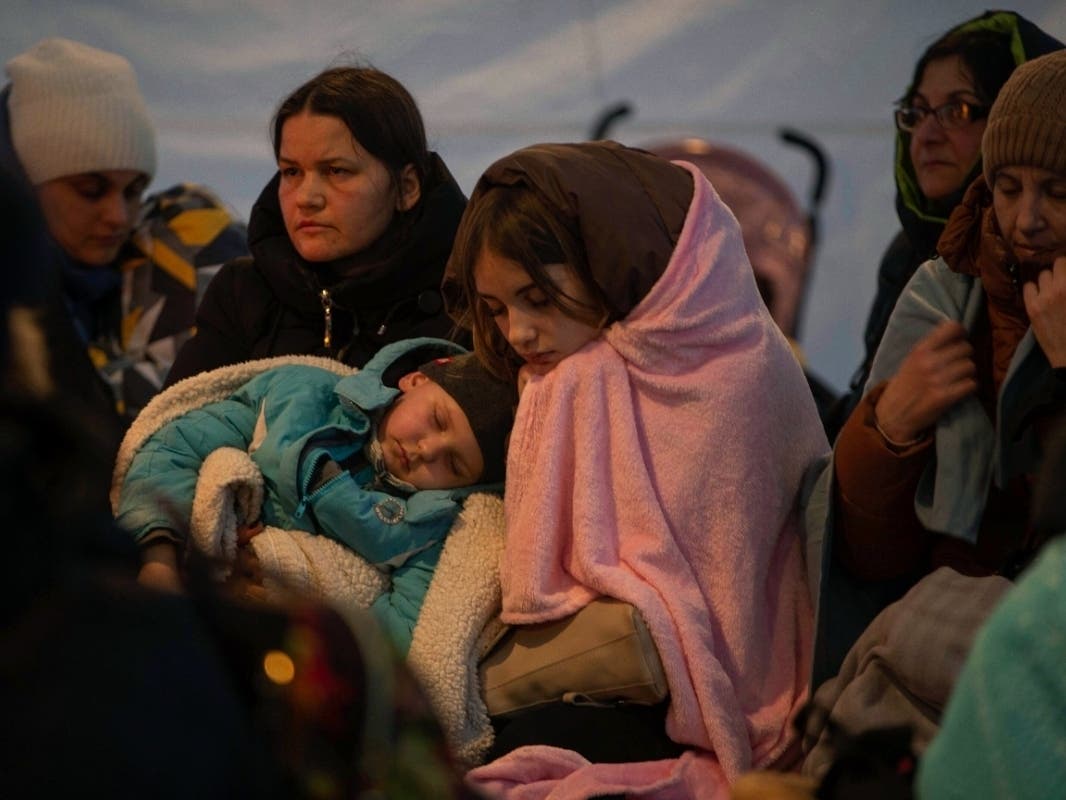 Refugees, mostly women with children, rest inside a tent after arriving at the border crossing, in Medyka, Poland on Sunday. More than 1.5 million people have fled Ukraine into neighboring countries since Russia's invasion 10 days ago.