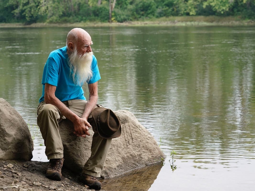 David Lidstone sits for a photograph near the Merrimack River last August in Boscawen, N.H. Lidstone, an off-the-grid New Hampshire hermit known to locals as "River Dave," had been living in a cabin in the woods along the Merrimack River.