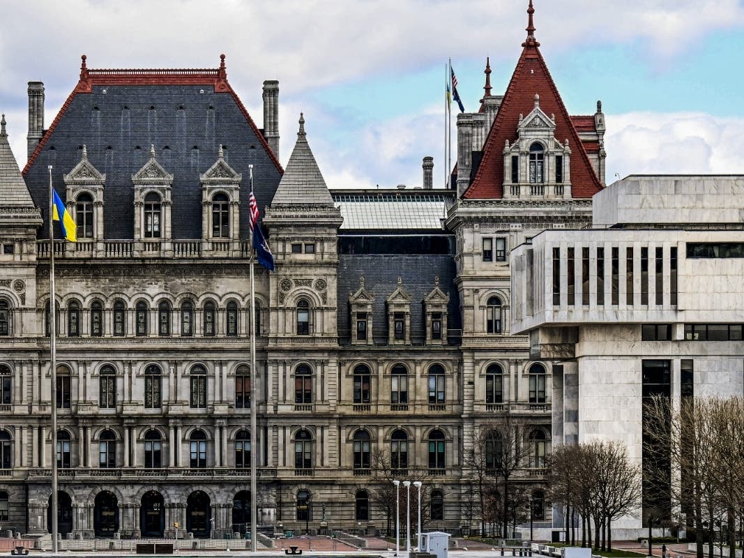 A partial views of the New York state Capitol building, left, is shown next to the state Appellate court building in foreground, right, Monday, April 4, 2022, in Albany, N.Y.