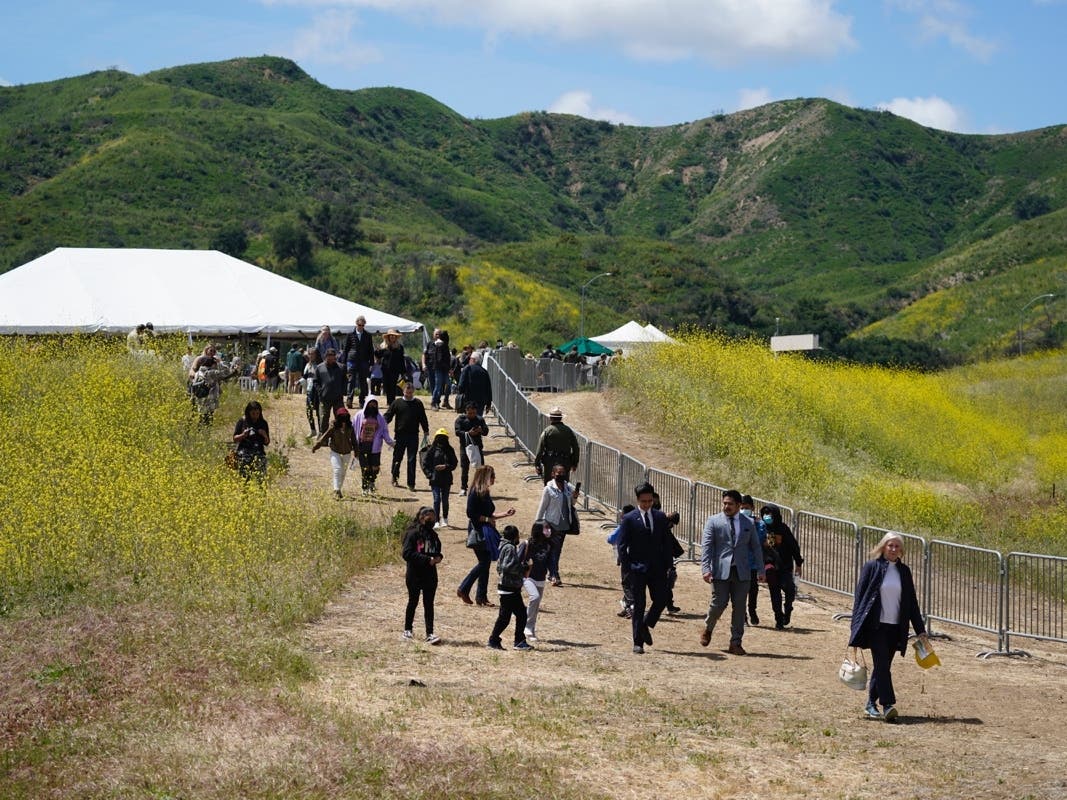 Attendees walk on a hiking path during a ground breaking ceremony for the Wallis Annenberg Wildlife Crossing Friday.