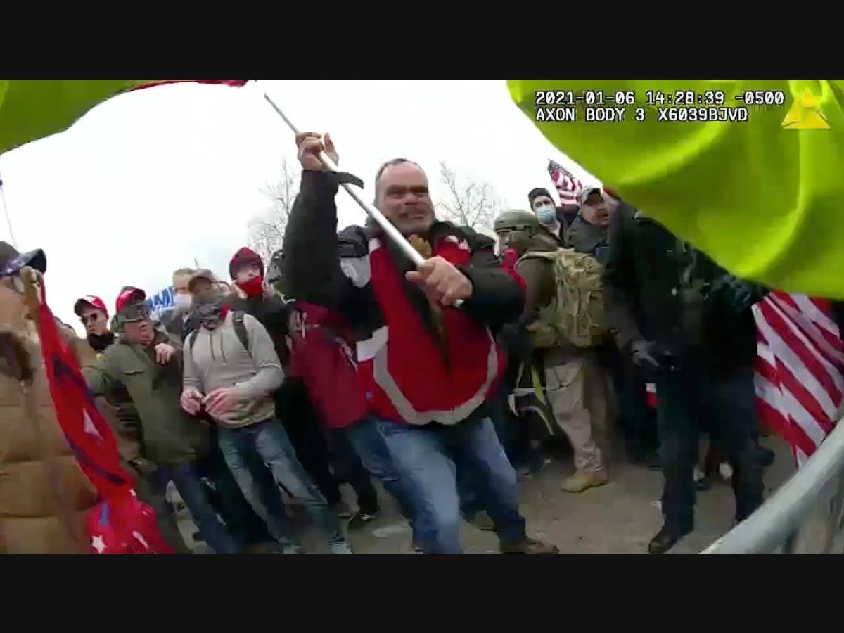 This still frame from Metropolitan Police Department body worn camera video shows Thomas Webster, in red jacket, at a barricade line at on the west front of the U.S. Capitol on Jan. 6, 2021, in Washington.