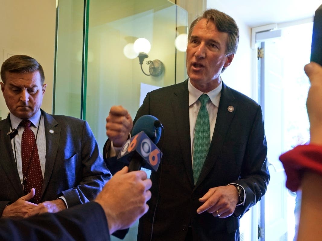 Virginia Gov. Glenn Youngkin, right, speaks to the media after leaving a meeting of the Senate Republican caucus at the Capitol Wednesday, April 27, 2022, in Richmond, Va. 