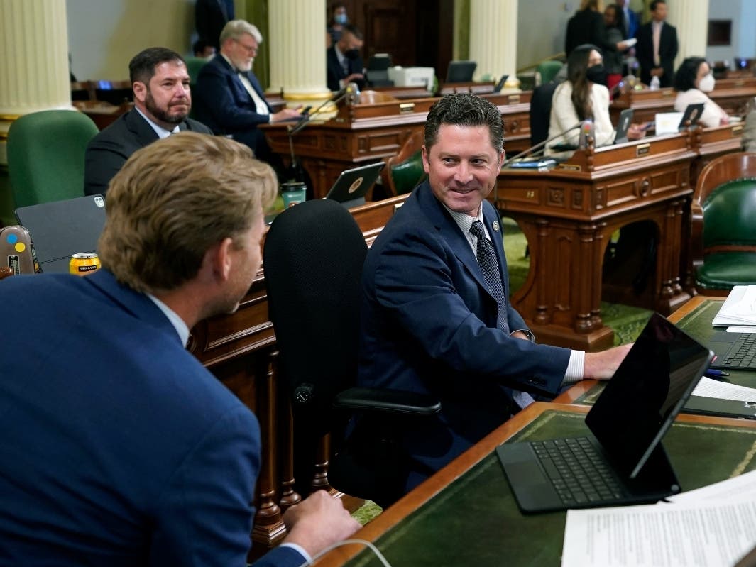 Assemblyman Jordon Cunningham, R-San Luis Obispo, right, smiles after his bill to hold social media companies responsible for harming children who have become addicted to their products was approved by the Assembly at the Capitol in Sacramento Monday.