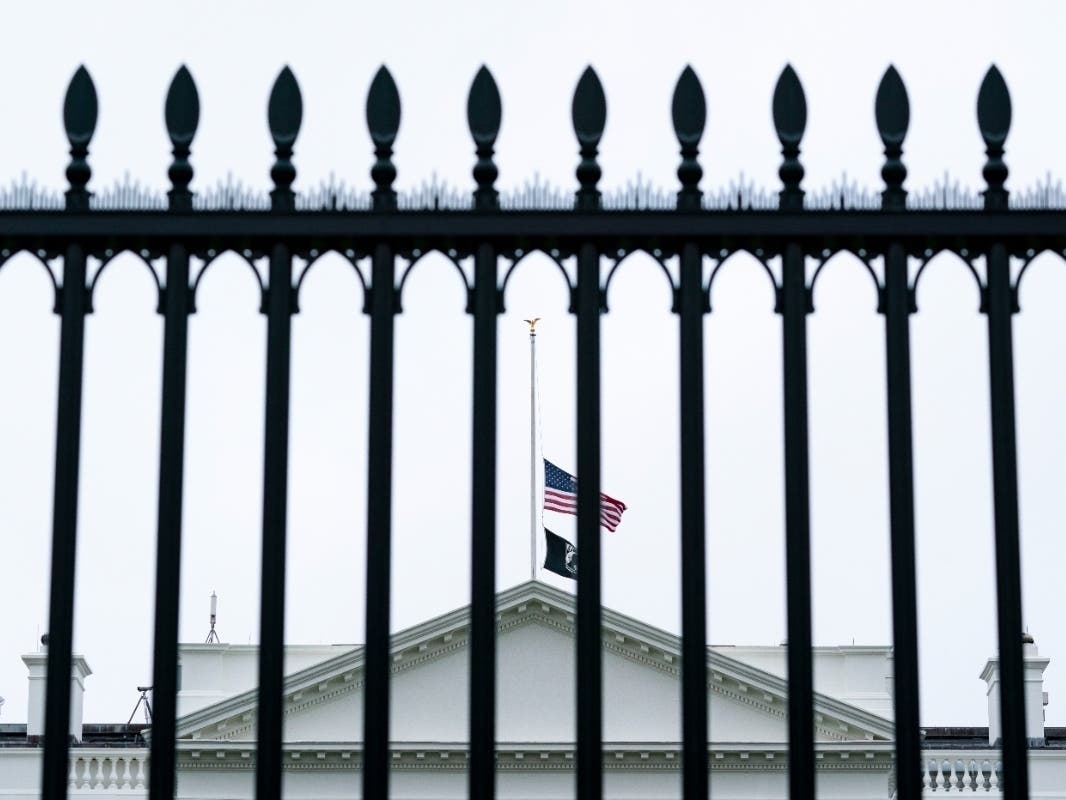 Flags fly at half-staff over the White House by order of President Joe Biden after a gunman killed 21 people, 19 of them young elementary school students, in Uvalde, Texas, on Tuesday.