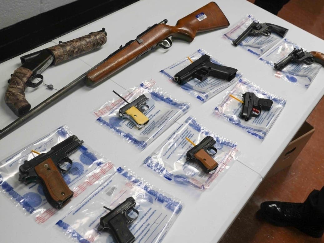A collection of illegal guns is displayed during a gun buyback event, May 22, 2021 in Brooklyn.
