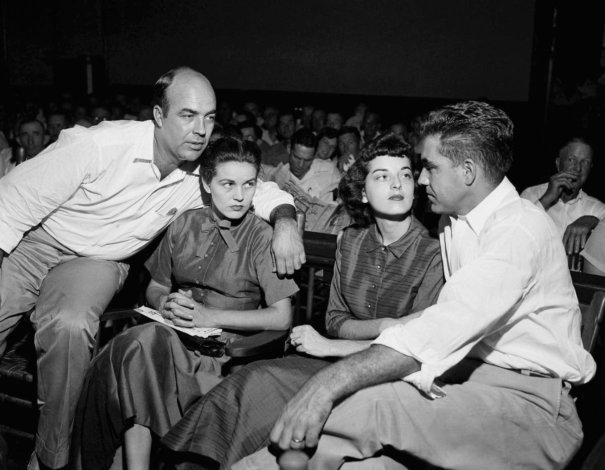 In this Sept. 23, 1955, file photo, J.W. Milam, left, his wife, second from left, Roy Bryant, far right, and his wife, Carolyn Bryant, sit together in a courtroom in Sumner, Mississippi.