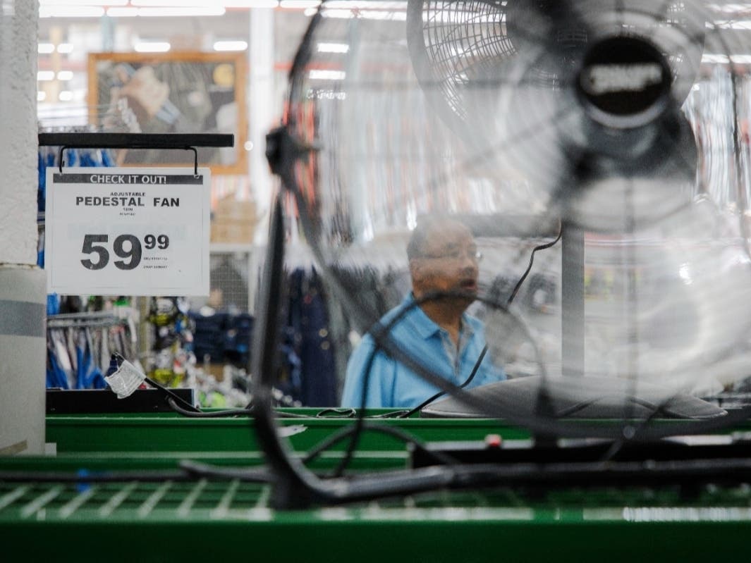 Stacks of air conditioners, fans and other cooling equipment line the entrance of McLendon Hardware in Renton, Wash., on Sunday, July 24, 2022. 