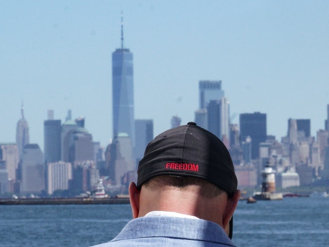 Eddie Bracken wears a cap with the word "freedom" while preparing for an interview at the Staten Island September 11th Memorial, in view of lower Manhattan, Friday Sept. 2, 2022, in New York. 