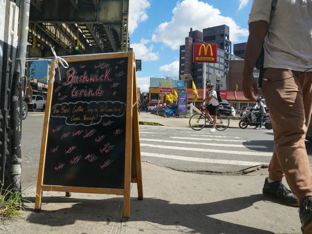 A sign alerts foot traffic to nearby Bushwick Grind Café just a few steps away from a McDonalds restaurant, Thursday Sept. 8, 2022, in New York. 