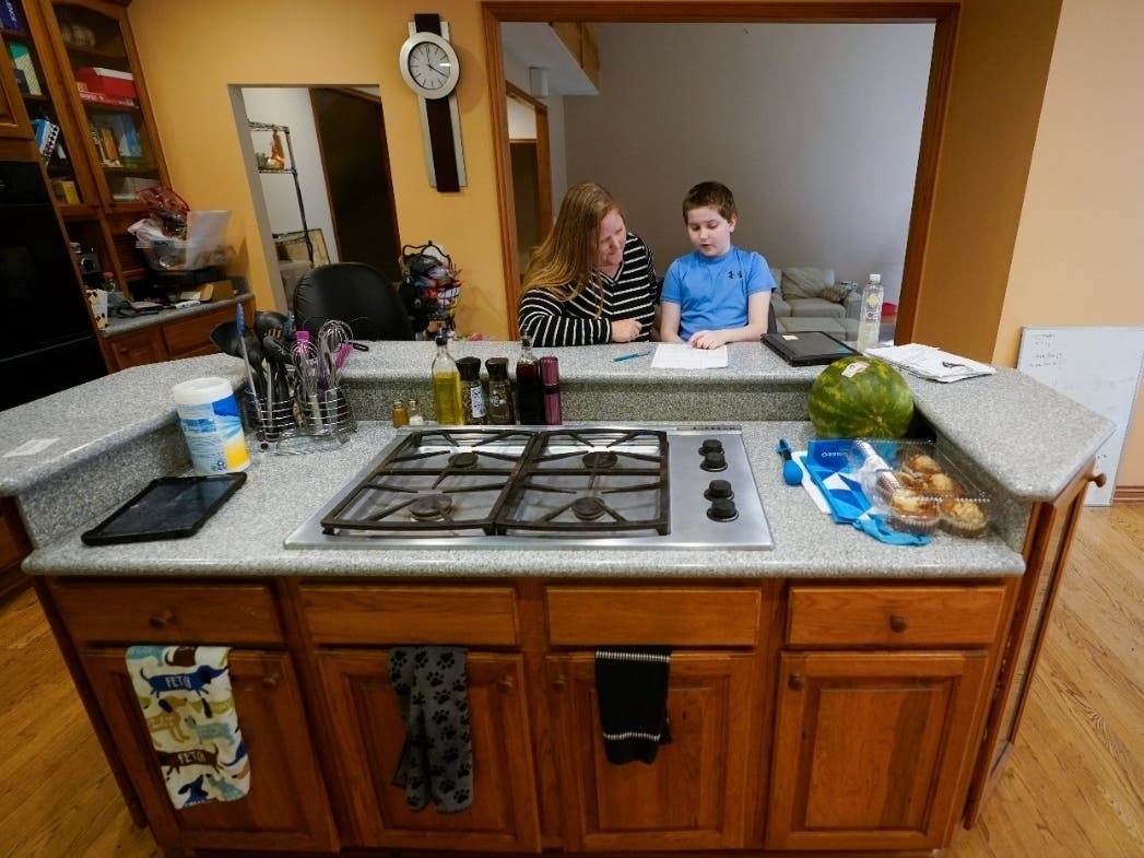 Lisa Manwell works on school work with her son John Jinks, 12, at their home in Canton, Michigan. Manwell says her son was improperly removed from his classroom last year because of behaviors that stemmed from his disability