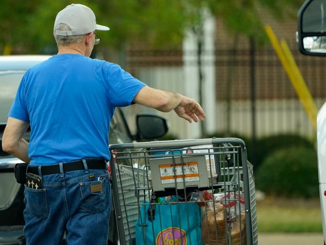 A shopper removes his purchases from his cart in Jackson, Miss., Wednesday, Oct. 12, 2022. 