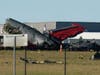 Debris from two planes that crashed during an airshow at Dallas Executive Airport lie on the ground Saturday, Nov. 12, 2022.