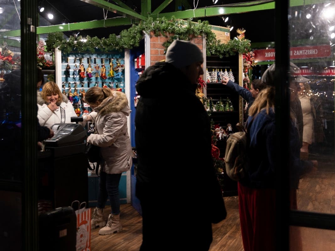 People shop for Christmas trinkets in Bryant Park's Winter Village, Tuesday, Nov. 15, 2022, in New York. After two years of pandemic holidays when people spent more dollars online, shoppers are back in force in stores and at holiday markets.