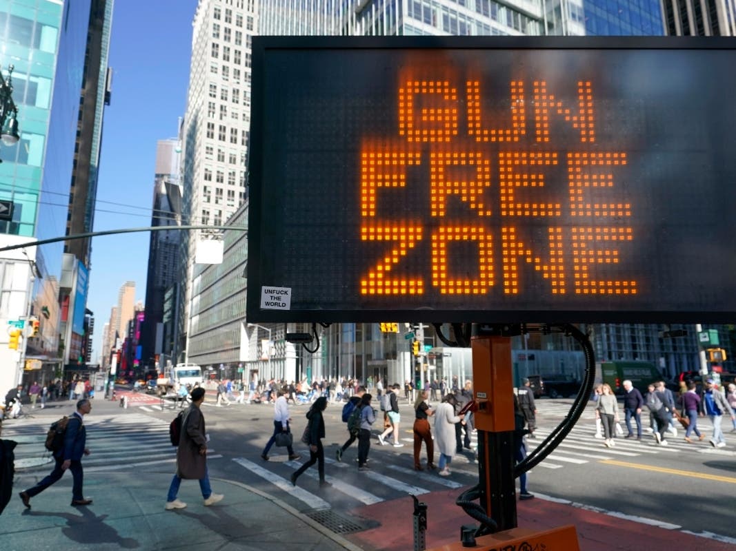 A traffic sign on the corner of 42nd Street and 6th Avenue announces Times Square as a gun free zone, Oct. 11, 2022, in New York.