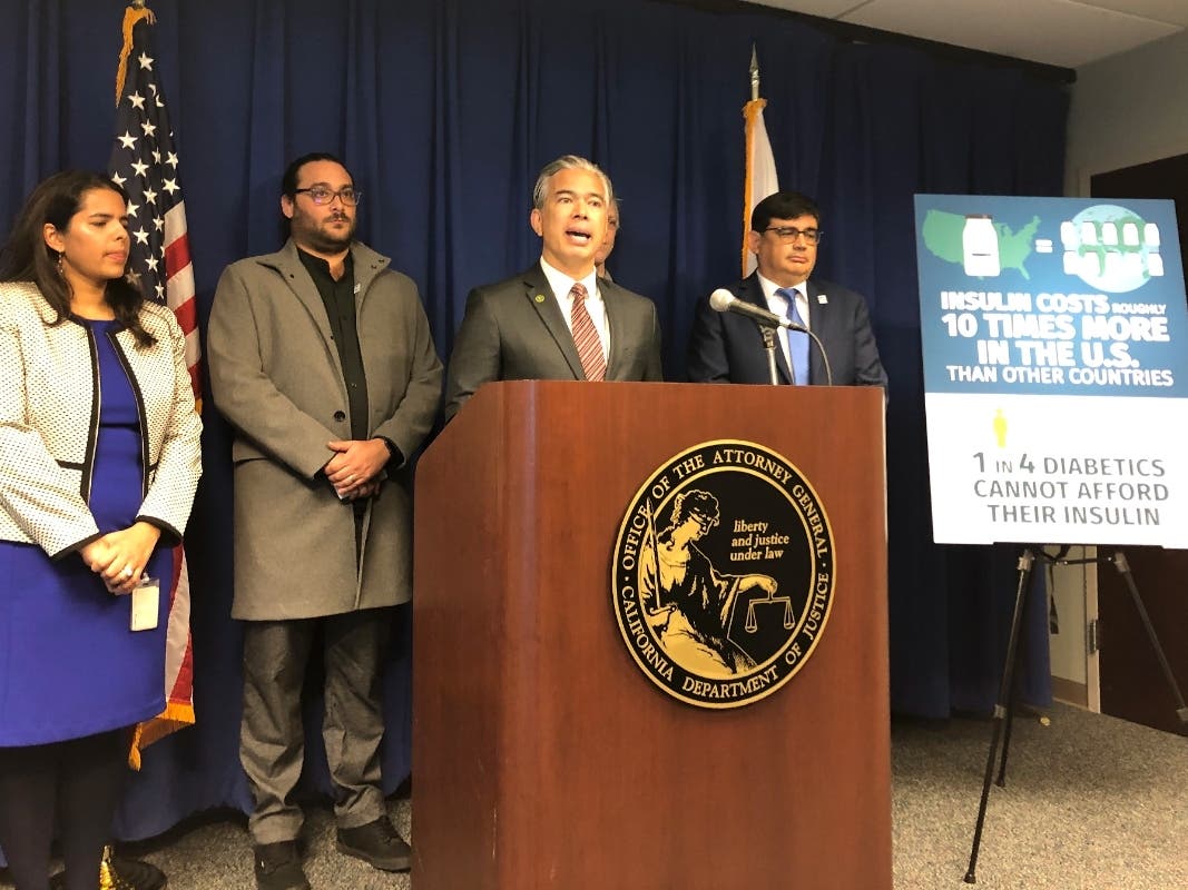 California Attorney General Rob Bonta, middle, speaks at a news conference in Sacramento, Calif., on Thursday, Jan. 12, 2023. Bonta announced a lawsuit accusing multiple companies that make or promote insulin of keeping prices too high.