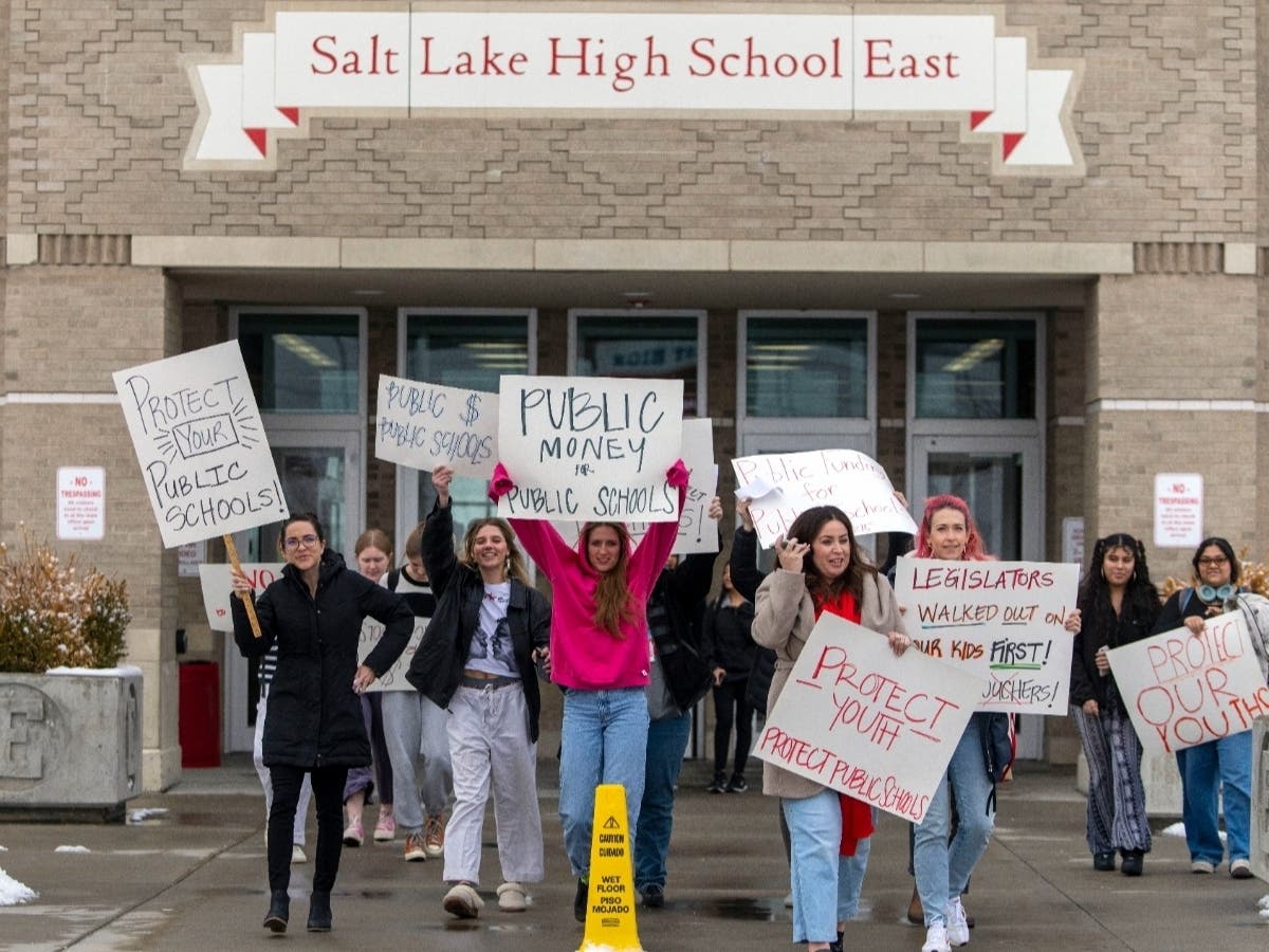 Students and teachers walk out of a Salt Lake City, Utah, high school Wednesday of a proposed bill that would channel state tax money to private and religious schools. At least a dozen states are considering similar legislation.