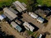 In this photo taken by a drone, a cluster of mobile homes is seen at the California Terra Garden, formerly Mountain Mushroom Farm in Half Moon Bay, Thursday, Jan. 26, 2023. 