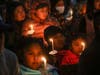 People gather at a community vigil for the Half Moon Bay shootings earlier in the week in Half Moon Bay, on Friday, Jan. 27, 2023.