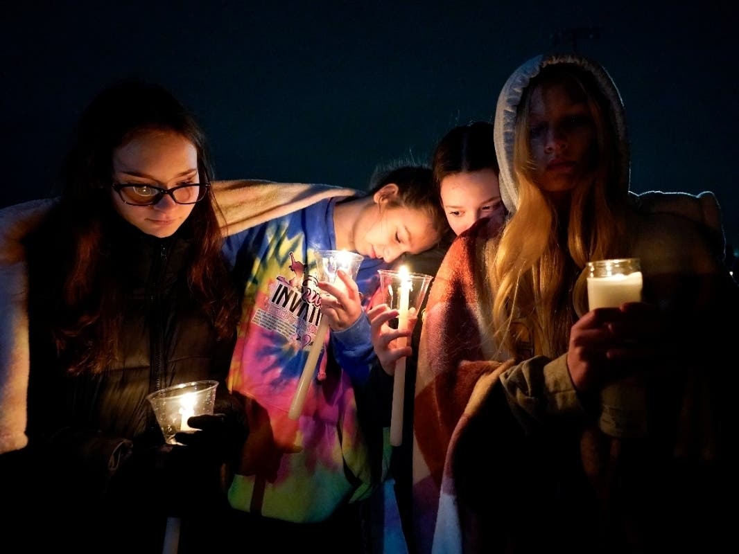 Mourners attend a candlelight vigil for Alexandria Verner at the Clawson High School football field in Clawson, Michigan, Tuesday. Verner was among the students killed after a gunman opened fire on the campus of Michigan State University Monday night. 