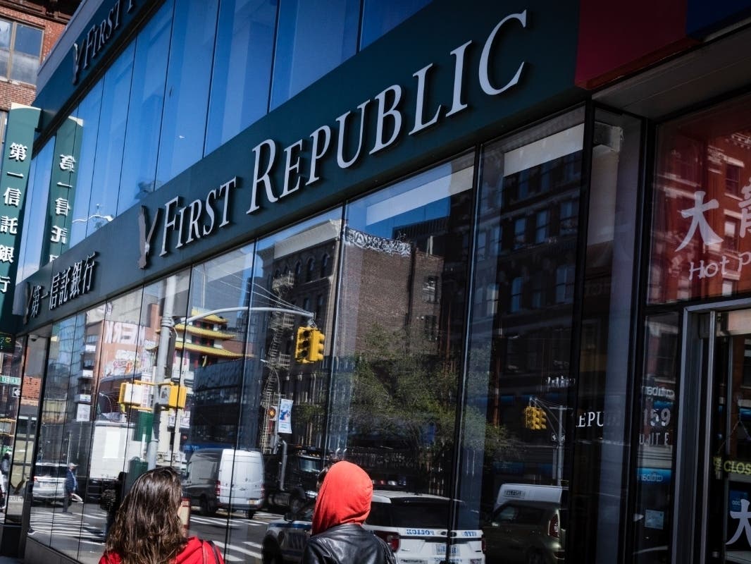 People walk past a First Republic Bank in New York, Monday, May 1, 2023. Regulators seized the troubled First Republic Bank early Monday, making it the second-largest bank failure in U.S. history.