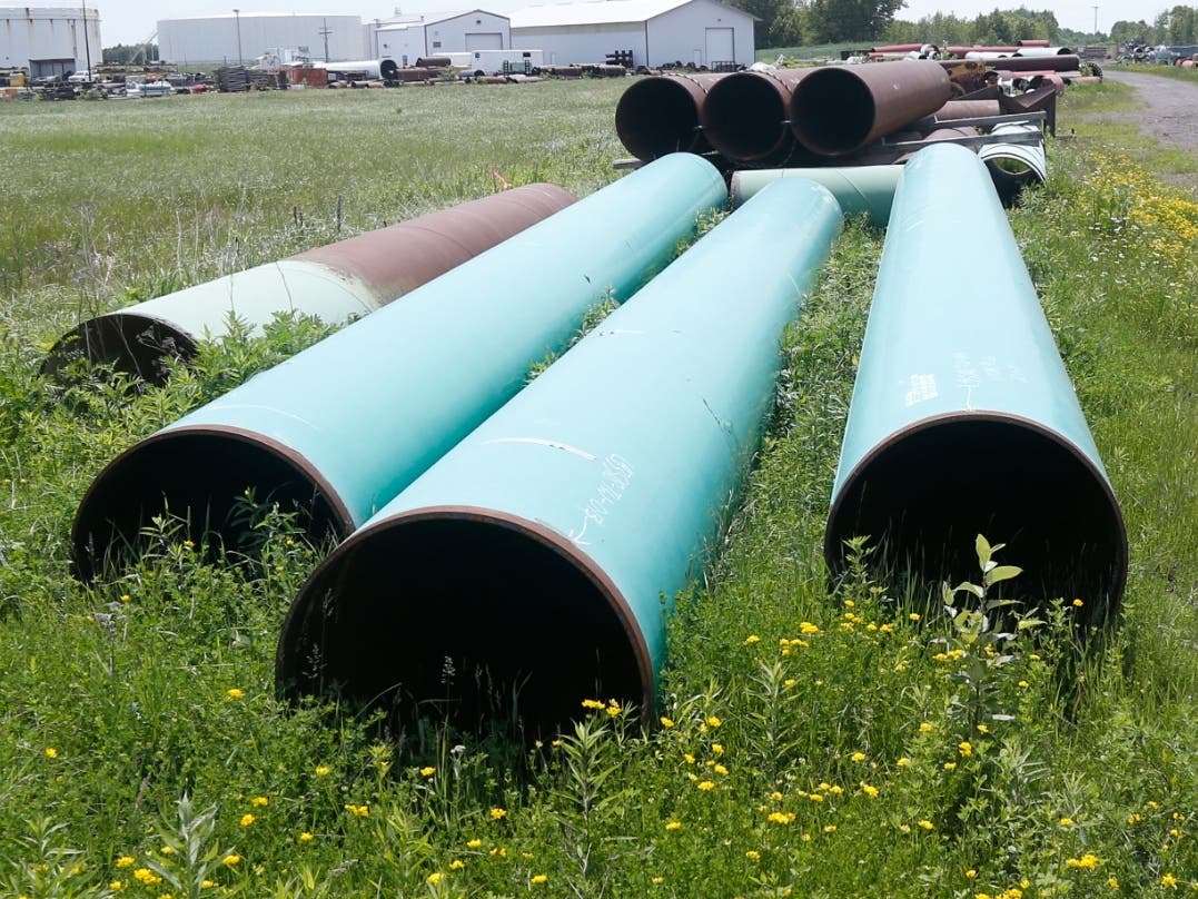 A pipeline used to carry crude oil sits at the Superior, Wis., terminal of Enbridge Energy in June 2018.