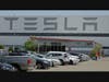  A man walks in the Tesla plant parking lot on May 11, 2020, in Fremont, Calif. Lawyers seeking to bring a class-action lawsuit against Tesla submitted declarations Monday, June 5, 2023, in Alameda County Superior Court.