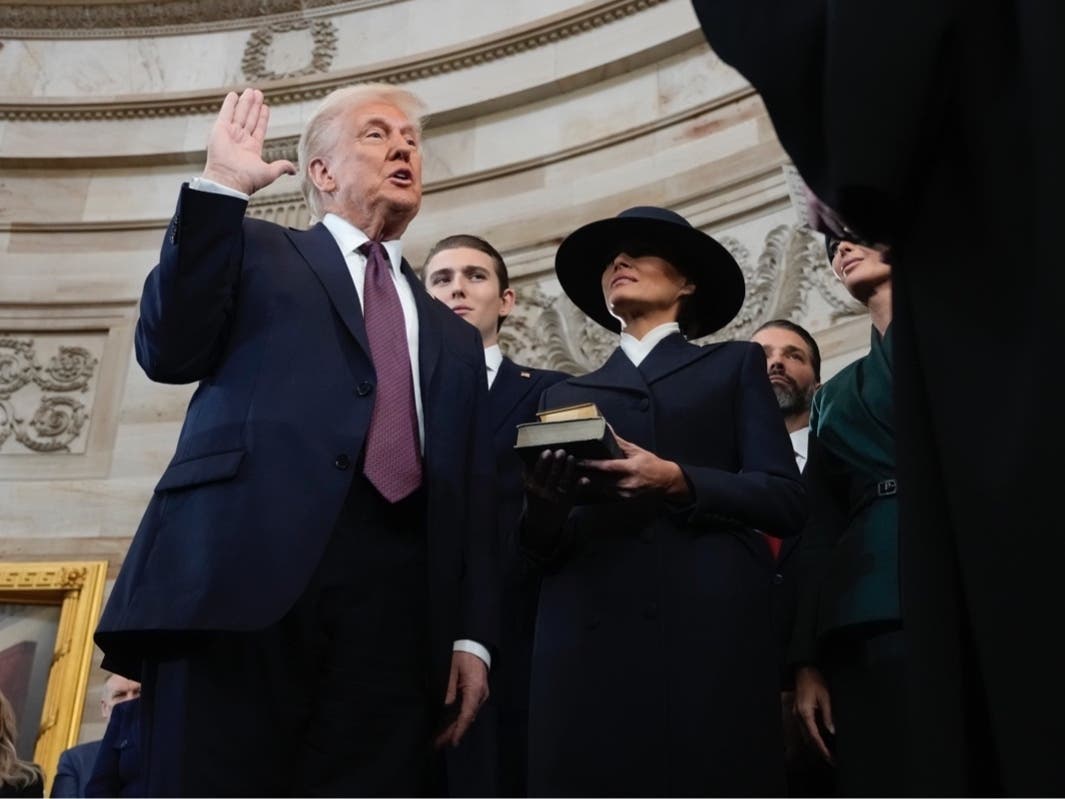 Donald Trump is sworn in as the 47th president of the United States by Chief Justice John Roberts as Melania Trump holds the Bible during the 60th Presidential Inauguration in the Rotunda of the U.S. Capitol in Washington, Monday, Jan. 20, 2025.